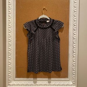 Women’s black, floral blouse.